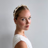 Bride with hair swept back wearing a unique pearl and crystal headband by Joanna Bisley Designs.