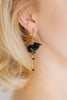 Closeup of bride wearing black bridal earrings.