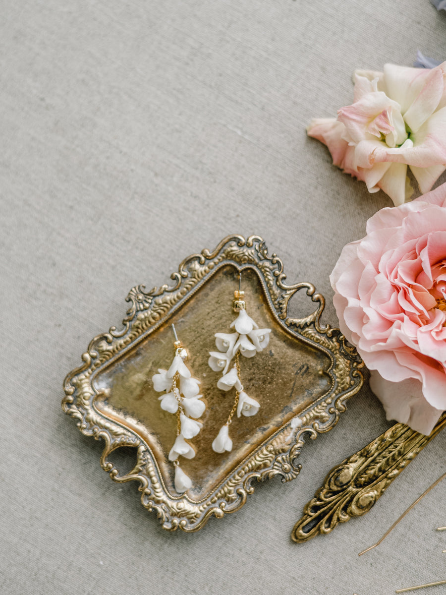 Detailed photo of flower and pearl long bridal earrings by Joanna Bisley Designs.