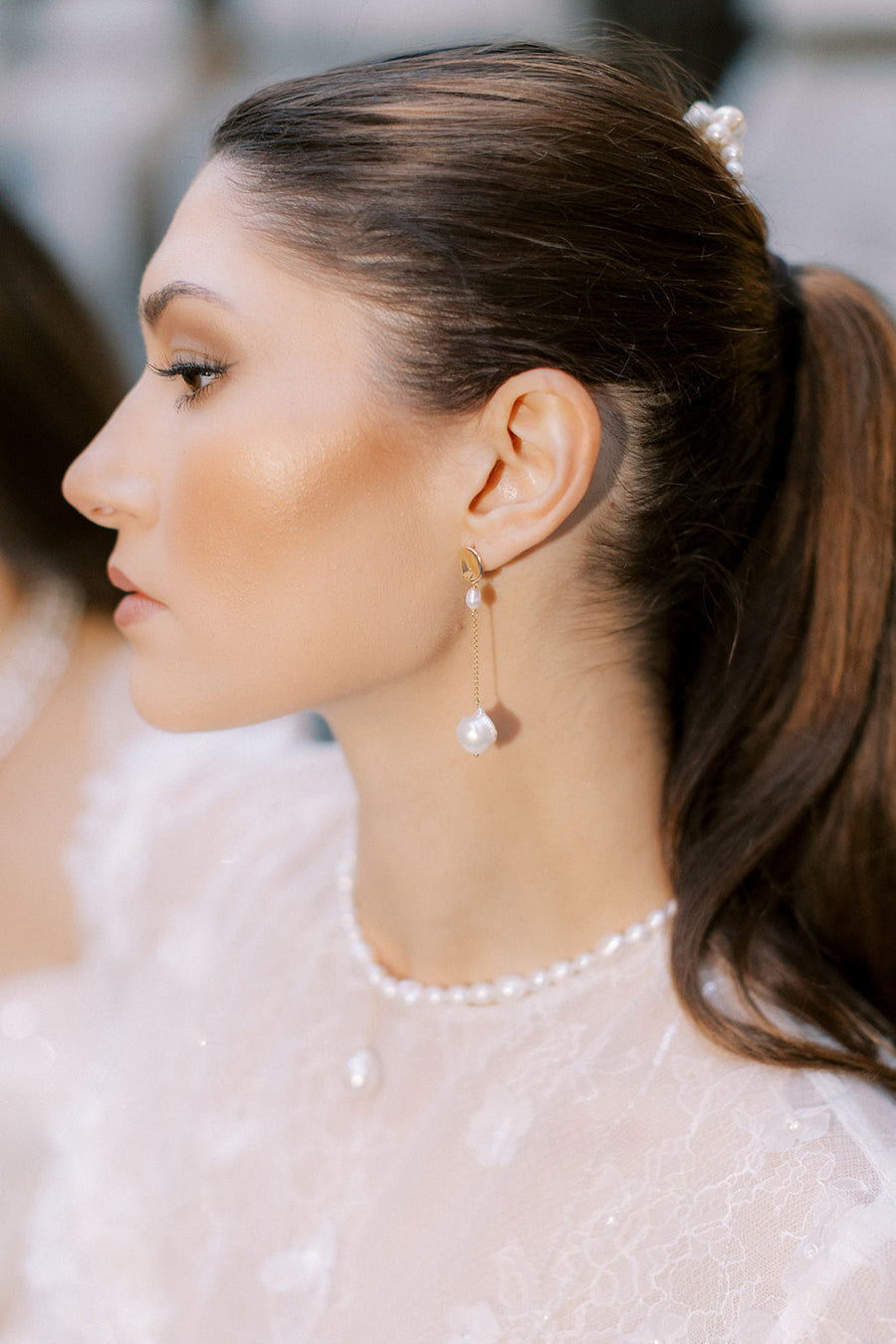 Bride wearing baroque pearl earrings and baroque pearl and freshwater bridal necklace.