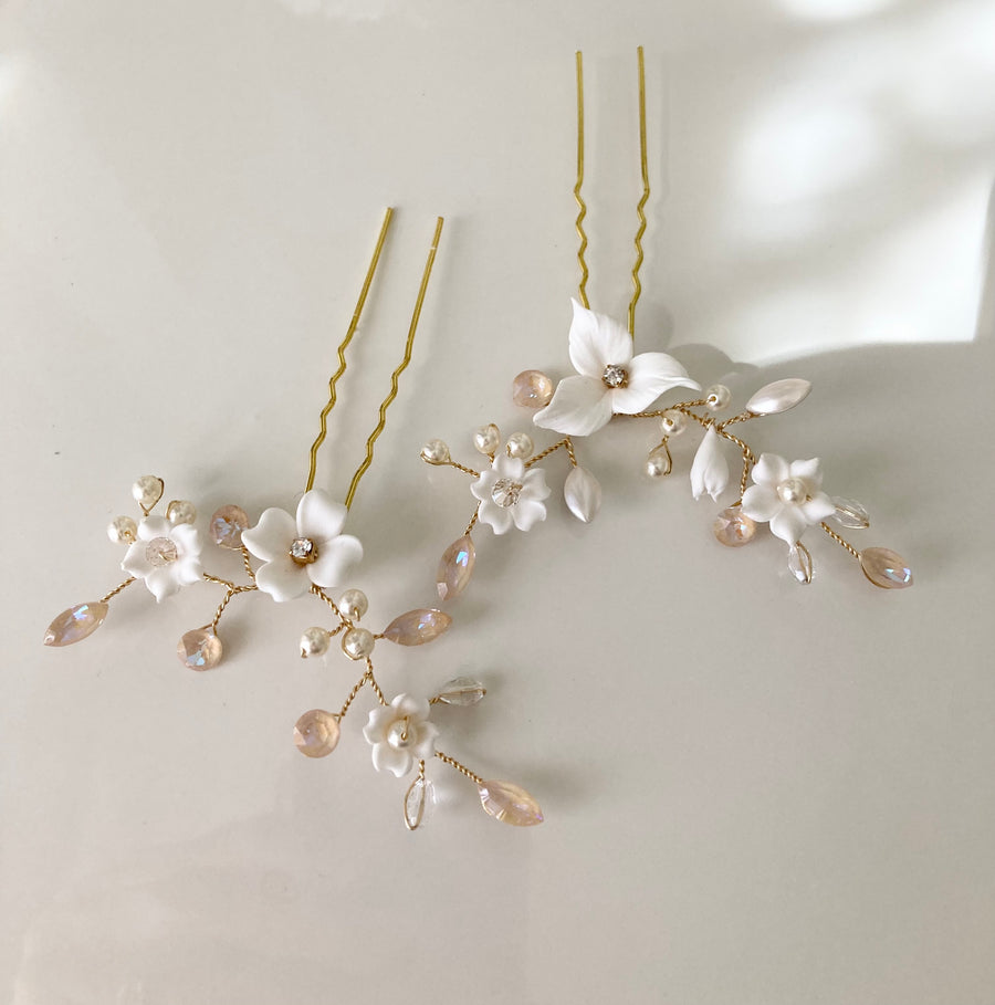 Wedding hairpins handcrafted with Swarovski Crystal, cream pearls and white florals.