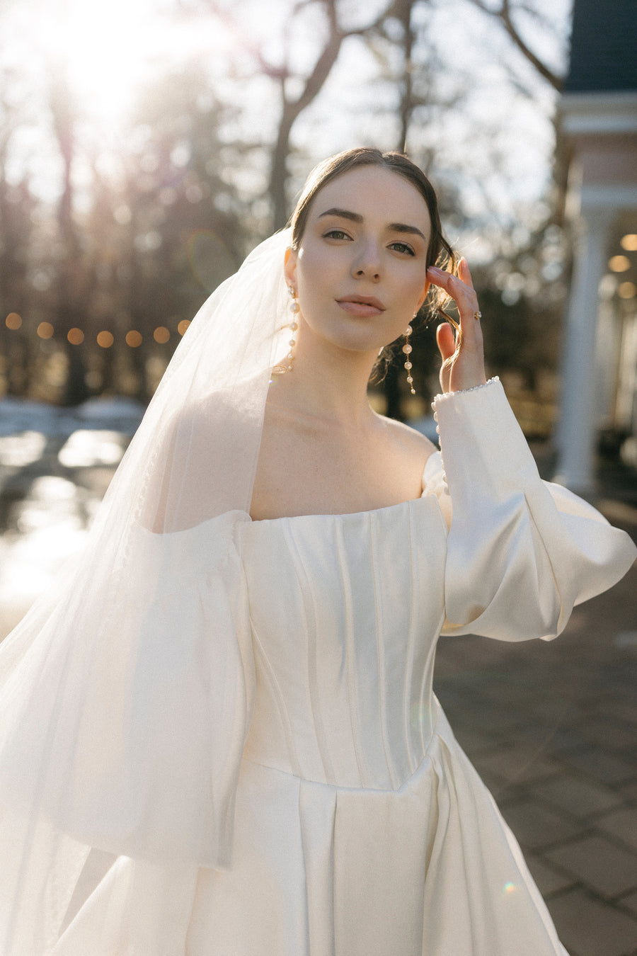 Calgary bride outside wearing long pearl bridal earrings by Joanna Bisley Designs