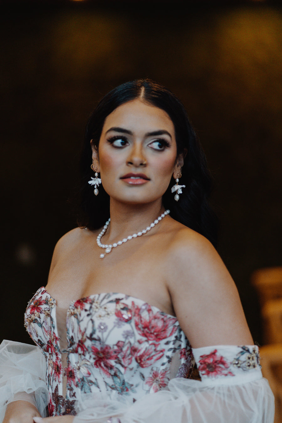 Bride wearing colorful gown wearing pearl bridal jewelry set by Joanna Bisley Designs.