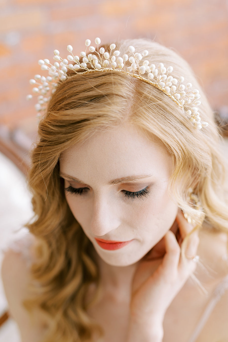 Bride with hair down wearing exquisite pearl bridal headband by Joanna Bisley Designs.