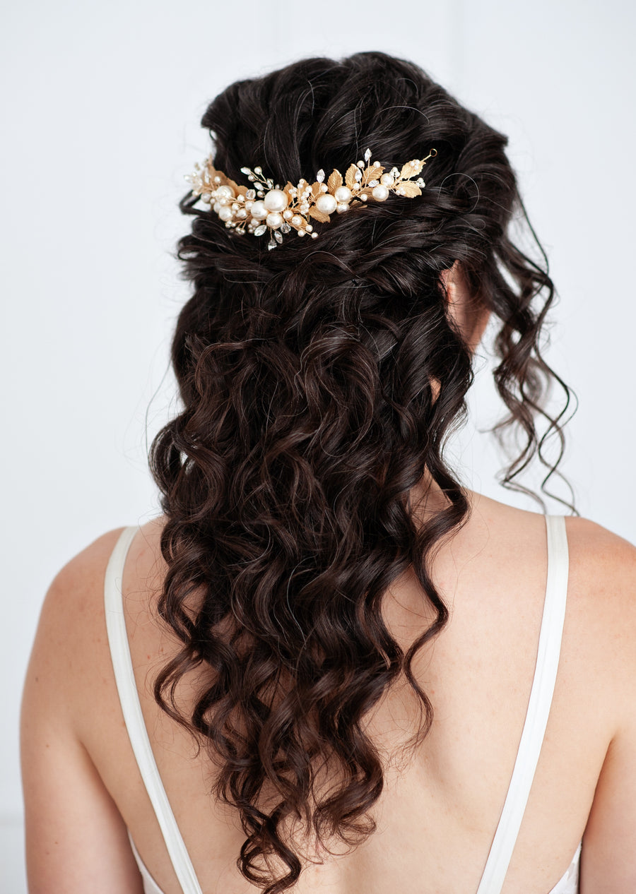 A bride with half up half down bridal hairstyle wearing a statement Wedding comb by Joanna Bisley Designs.