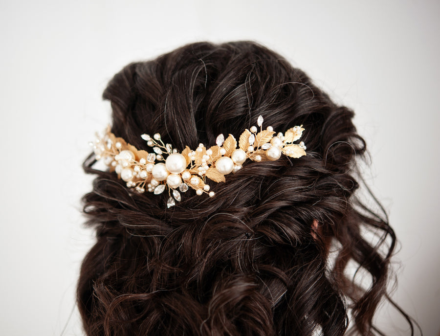 Bride with half up half down bridal hairstyle wearing a luxury statement wedding hairpiece by Joanna Bisley Designs.