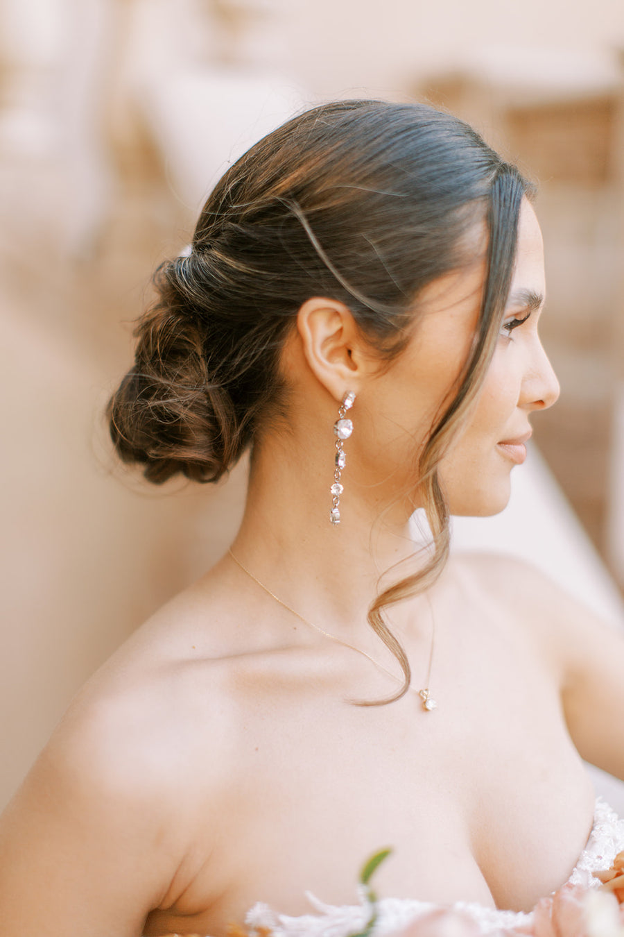 Bride wearing long crystal bridal earrings by Canadian Designer Joanna Bisley Designs.