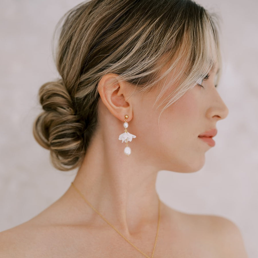 Bride wearing flower and pearl earrings by Joanna Bisley Designs. 