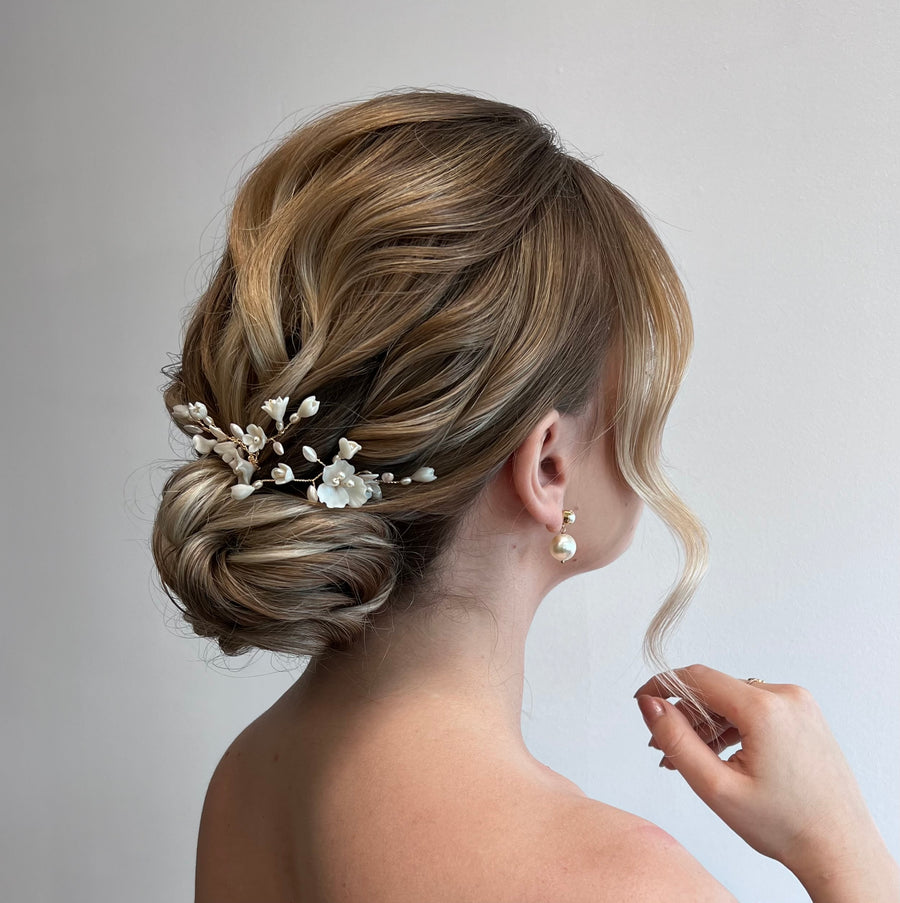 Bride with elegant updo wearing joanna bisley designs bridal pins.