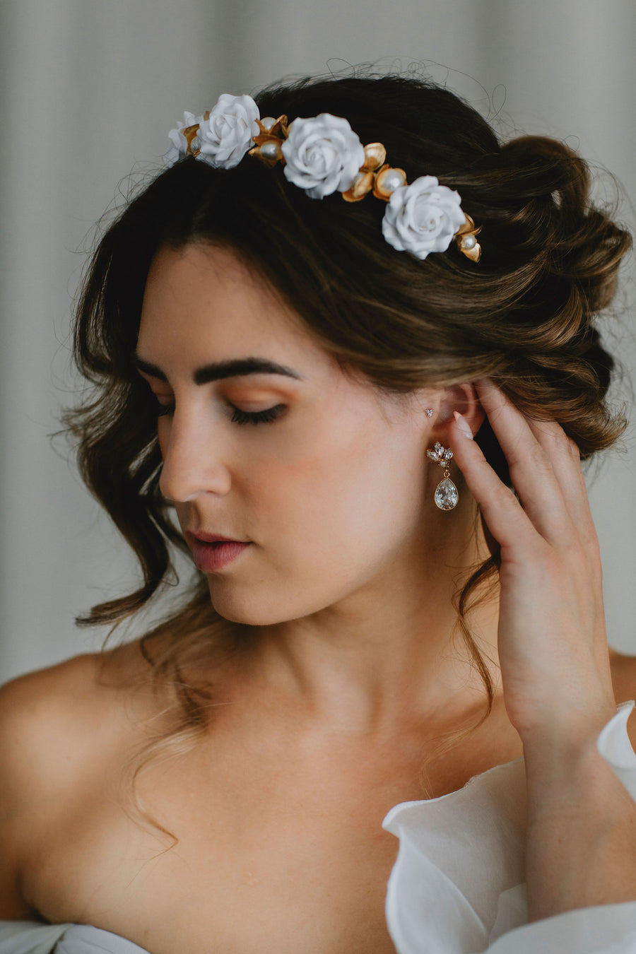 Bride with romantic bridal updo wearing a statement rose flower crown by Joanna Bisley Designs.