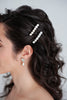 Bride wearing two crystal and pearl bridal barettes handcrafted in Calgary by Joanna Bisley Designs.