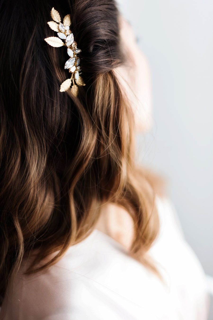 Bride wearing her hair down with a luxury bridal comb pulling her hair back to one side.