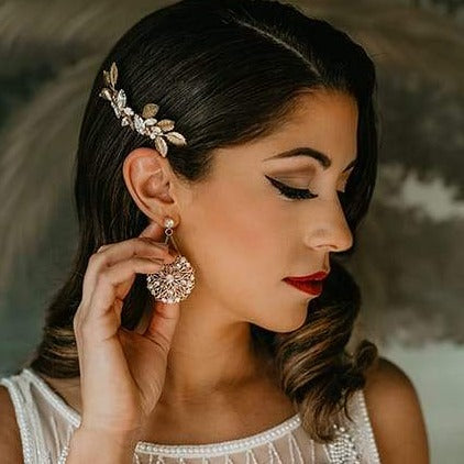 Bride wearing an elegant crystal and leaf bridal comb in gold, handcrafted by Joanna Bisley Designs.