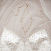 Bridal back necklace of pearls and crystals styled with an exquisite bridal gown.